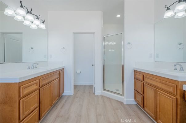 Bathroom, Dual Sink Vanities, Glass Shower, Interior, Recessed Lighting, Wood Texture Flooring