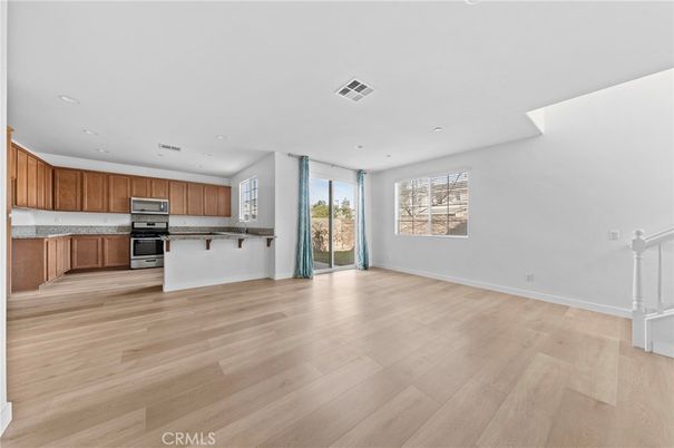 Empty room, Interior, Kitchen, Recessed Lighting, Stainless Steel Appliances, Wood Texture Flooring