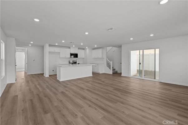 Empty room, Interior, Kitchen, Recessed Lighting, Stainless Steel Appliances, Wood Texture Flooring