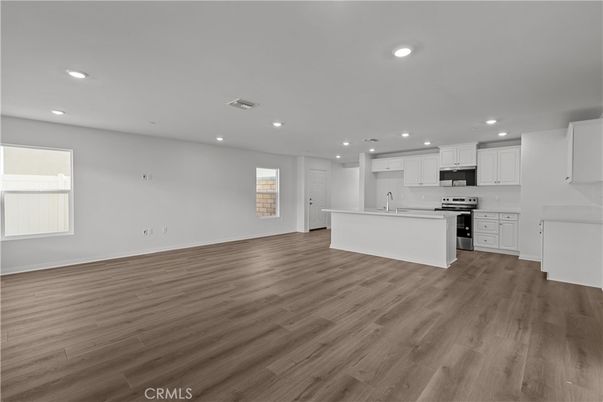 Empty room, Interior, Kitchen, Recessed Lighting, Stainless Steel Appliances, Wood Texture Flooring