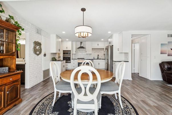 Chandelier, Dining room, Interior, Kitchen, Pendant Lights, Recessed Lighting, Stainless Steel Appliances, Stone Walls, Wood Texture Flooring