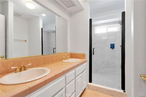 Bathroom, Dual Sink Vanities, Glass Shower, Interior, Marble Walls, Recessed Lighting, Tile Countertops