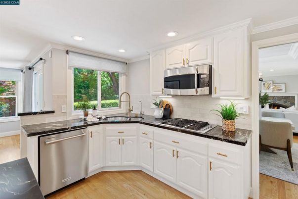 Fireplace, Interior, Kitchen, Recessed Lighting, Stainless Steel Appliances, Wood Texture Flooring