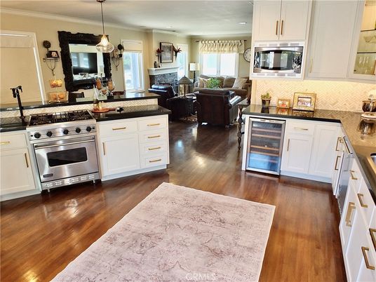 Fireplace, Interior, Kitchen, Living room, Pendant Lights, Recessed Lighting, Stainless Steel Appliances, Wood Texture Flooring
