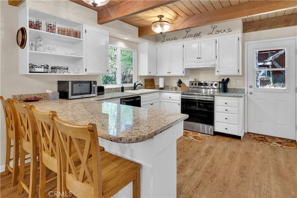 Chandelier, Dining room, Fireplace, Interior, Living room, Stone Walls, Wooden Beams, Wooden Ceilings, Wood Texture Flooring