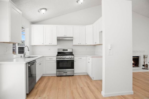 Fireplace, Interior, Kitchen, Stainless Steel Appliances, Wood Texture Flooring