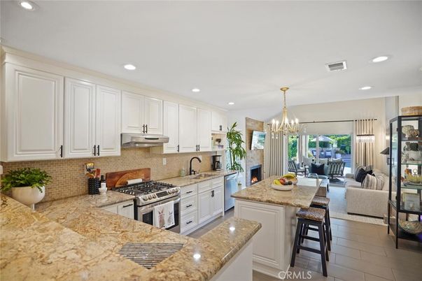 Chandelier, Dining room, Fireplace, Interior, Kitchen, Living room, Pendant Lights, Recessed Lighting, Stainless Steel Appliances