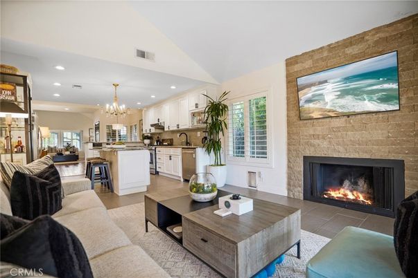 Chandelier, Fireplace, Interior, Kitchen, Living room, Recessed Lighting, Stone Walls, Wood Texture Flooring
