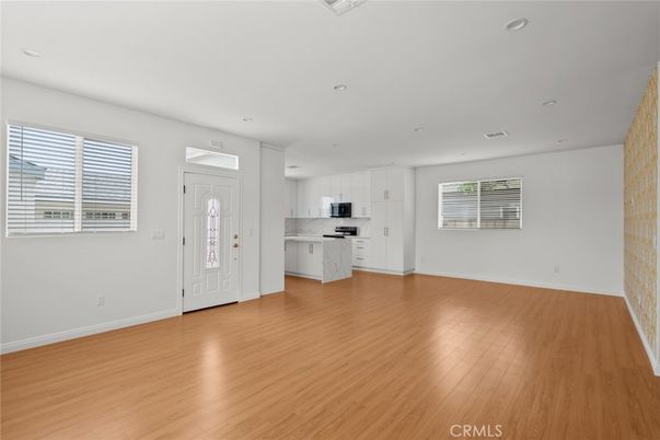 Empty room, Interior, Kitchen, Recessed Lighting, Stainless Steel Appliances, Wood Texture Flooring