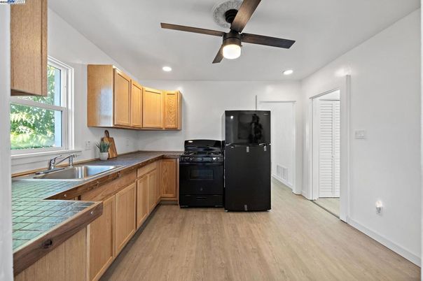 Interior, Kitchen, Recessed Lighting, Tile Countertops, Wood Texture Flooring