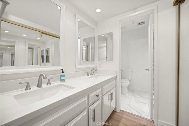 Bathroom, Dual Sink Vanities, Interior, Marble, Recessed Lighting, Wood Texture Flooring