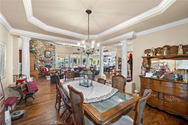 Chandelier, Dining room, Fireplace, Interior, Living room, Pendant Lights, Stone Walls, Wood Texture Flooring