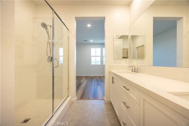 Bathroom, Dual Sink Vanities, Glass Shower, Interior, Recessed Lighting, Wood Texture Flooring