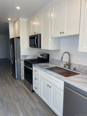 Interior, Kitchen, Recessed Lighting, Tile Countertops, Wood Texture Flooring