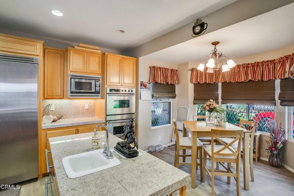 Chandelier, Dining room, Interior, Kitchen, Recessed Lighting, Stainless Steel Appliances, Wood Texture Flooring