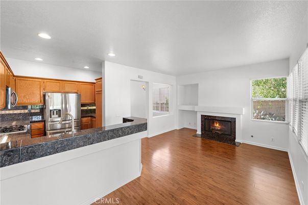 Fireplace, Interior, Kitchen, Recessed Lighting, Stainless Steel Appliances, Wood Texture Flooring