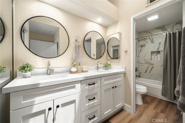 Bathroom, Dual Sink Vanities, Interior, Marble Walls, Recessed Lighting, Wood Texture Flooring