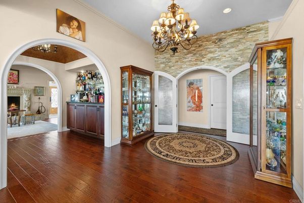 Chandelier, Fireplace, Interior, Recessed Lighting, Stone Walls, Wood Texture Flooring