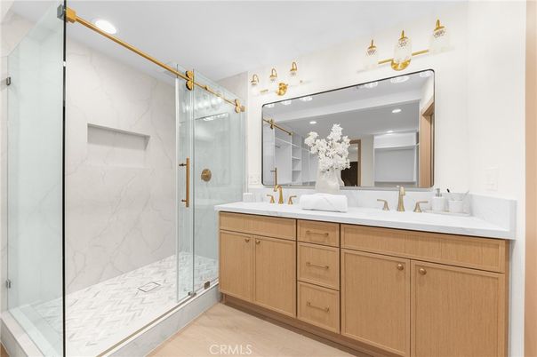 Bathroom, Dual Sink Vanities, Glass Shower, Interior, Marble Walls, Recessed Lighting, Wood Texture Flooring