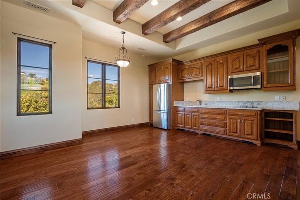 Empty room, Interior, Kitchen, Pendant Lights, Recessed Lighting, Stainless Steel Appliances, Wooden Beams, Wood Texture Flooring