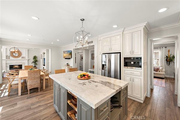 Chandelier, Dining room, Fireplace, Interior, Kitchen, Pendant Lights, Recessed Lighting, Stainless Steel Appliances, Wood Texture Flooring