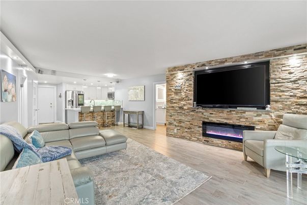 Fireplace, Interior, Kitchen, Living room, Pendant Lights, Recessed Lighting, Stainless Steel Appliances, Stone Walls, Wood Texture Flooring