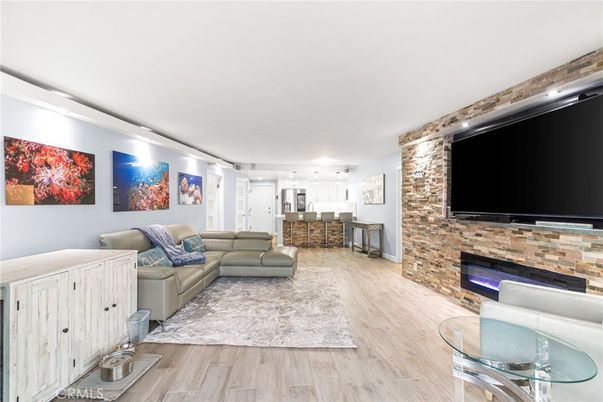 Fireplace, Interior, Living room, Recessed Lighting, Stone Walls, Wood Texture Flooring