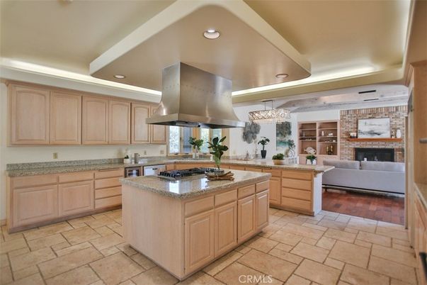 Chandelier, Fireplace, Interior, Kitchen, Living room, Recessed Lighting, Stainless Steel Appliances, Stone Walls, Wood Texture Flooring