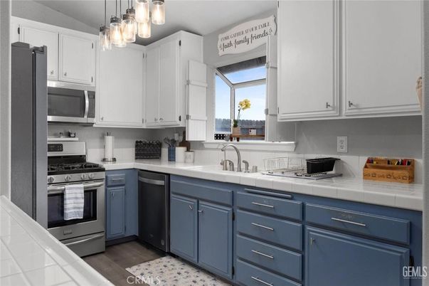Interior, Kitchen, Stainless Steel Appliances, Tile Countertops, Wood Texture Flooring