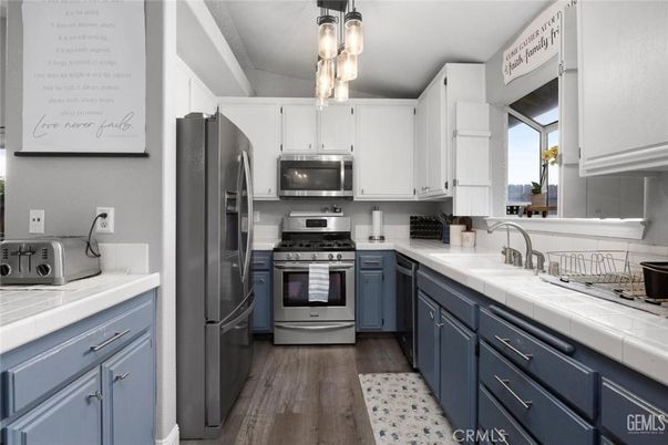 Interior, Kitchen, Stainless Steel Appliances, Tile Countertops, Wood Texture Flooring