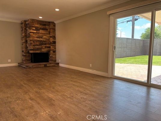 Empty room, Fireplace, Interior, Recessed Lighting, Stone Walls, Wood Texture Flooring