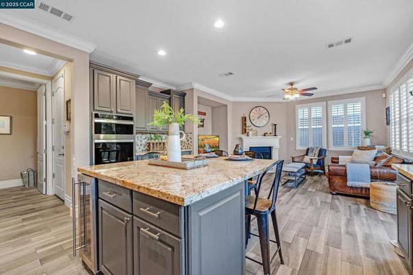 Fireplace, Interior, Kitchen, Living room, Recessed Lighting, Stainless Steel Appliances, Wood Texture Flooring