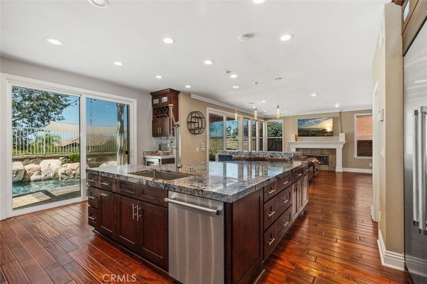 Fireplace, Interior, Kitchen, Pendant Lights, Recessed Lighting, Stainless Steel Appliances, Wood Texture Flooring