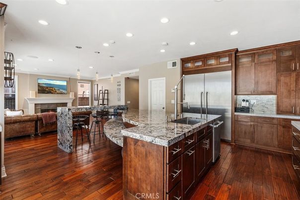 Fireplace, Interior, Kitchen, Living room, Pendant Lights, Recessed Lighting, Stainless Steel Appliances, Wood Texture Flooring
