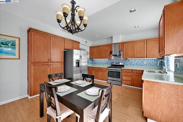 Chandelier, Dining room, Interior, Kitchen, Recessed Lighting, Stainless Steel Appliances, Wood Texture Flooring