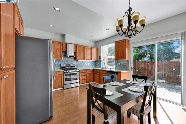 Chandelier, Dining room, Interior, Kitchen, Recessed Lighting, Stainless Steel Appliances, Wood Texture Flooring
