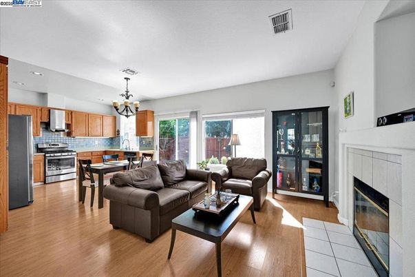 Chandelier, Dining room, Fireplace, Interior, Kitchen, Living room, Recessed Lighting, Stainless Steel Appliances, Wood Texture Flooring