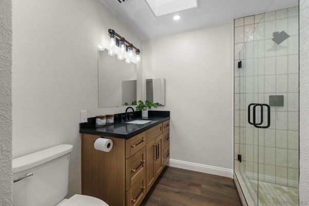 Bathroom, Dual Sink Vanities, Glass Shower, Interior, Recessed Lighting, Wood Texture Flooring
