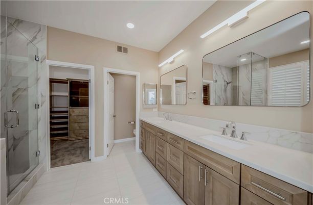 Bathroom, Dual Sink Vanities, Glass Shower, Interior, Marble Walls, Recessed Lighting, Walk-in Closets