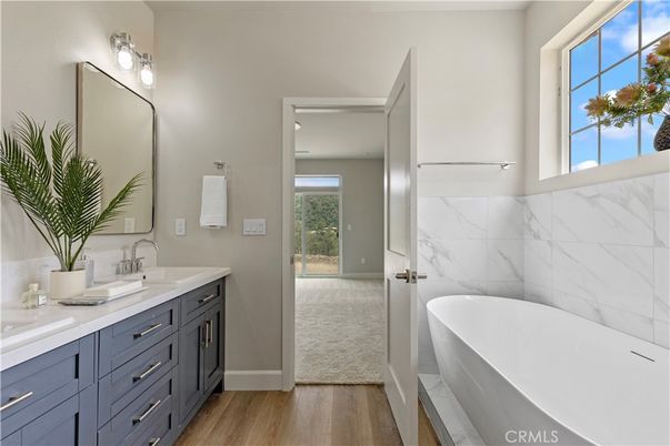 Bathroom, Dual Sink Vanities, Free Standing Baths, Interior, Marble Walls, Wood Texture Flooring