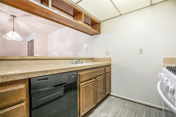 Interior, Kitchen, Pendant Lights, Tile Countertops, Wood Texture Flooring
