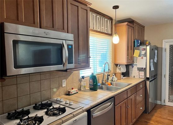 Interior, Kitchen, Pendant Lights, Stainless Steel Appliances, Tile Countertops, Wood Texture Flooring
