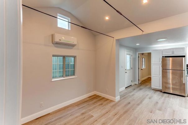 Empty room, Interior, Kitchen, Recessed Lighting, Stainless Steel Appliances, Wood Texture Flooring