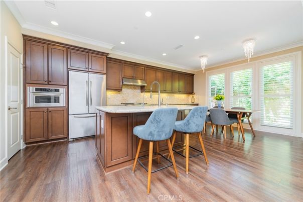 Chandelier, Dining room, Interior, Kitchen, Recessed Lighting, Stainless Steel Appliances, Wood Texture Flooring