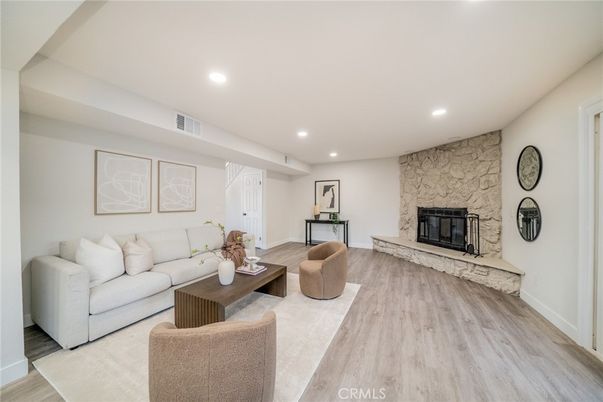 Fireplace, Interior, Living room, Recessed Lighting, Stone Walls, Wood Texture Flooring