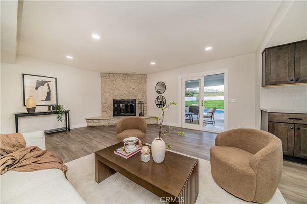 Fireplace, Interior, Living room, Recessed Lighting, Stone Walls, Wood Texture Flooring
