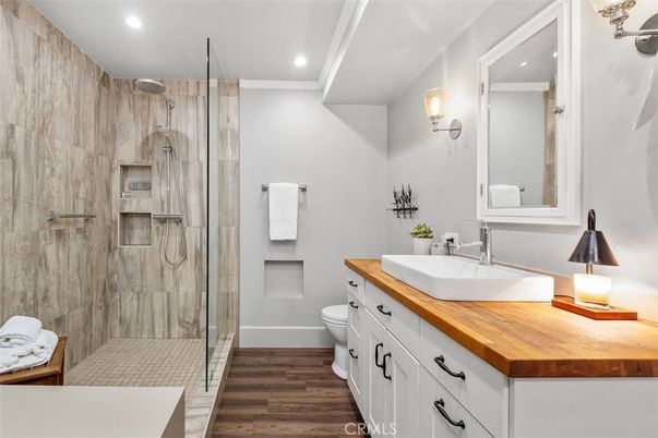 Bathroom, Dual Sink Vanities, Glass Shower, Interior, Recessed Lighting, Wood Texture Flooring