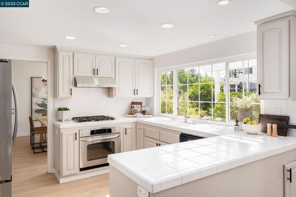 Interior, Kitchen, Recessed Lighting, Stainless Steel Appliances, Tile Countertops, Wood Texture Flooring