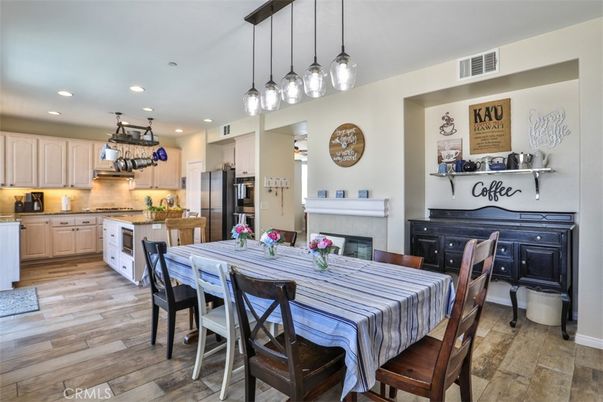 Dining room, Fireplace, Interior, Kitchen, Pendant Lights, Recessed Lighting, Stainless Steel Appliances, Wood Texture Flooring