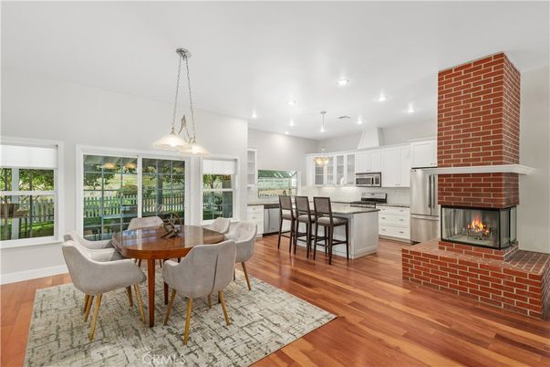 Dining room, Fireplace, Interior, Kitchen, Pendant Lights, Recessed Lighting, Stainless Steel Appliances, Wood Texture Flooring
